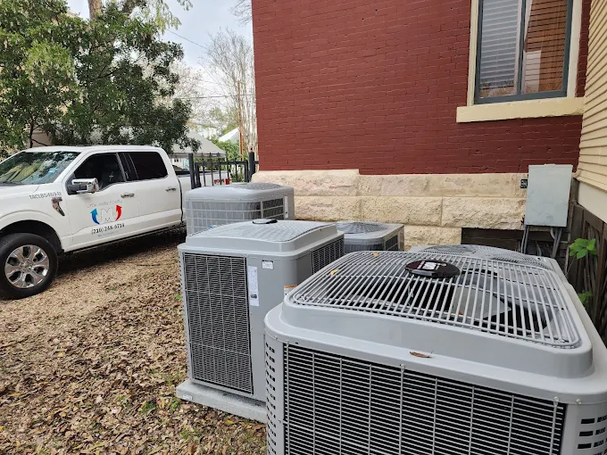 Real Miller Cooling & Heating AC condenser installation with service truck in San Antonio, TX